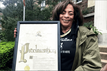 Gena Gunn McClendon holds the mayoral proclamation declaring May 8 the John Lewis Voting Advancement Action Day in St. Louis.